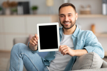 Poster - Happy young man showing tablet computer with mockup for website or application on screen, indoors