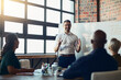 © Nola V/peopleimages.com - This is our target market. Cropped shot of a mature businessman giving a presentation in the boardroom.