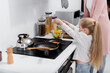 © LIGHTFIELD STUDIOS - mature woman with little granddaughter preparing salad in kitchen.