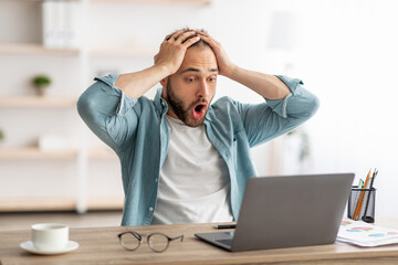 Poster - Terrified male freelancer looking at laptop, grabbing head, making error in business project, missing deadline at home