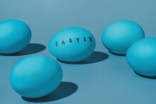 Five Blue Eggs One Egg With The Word Easter Written On It