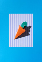 A Cardboard Carrot On A Blue Background