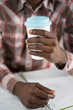 © Svyatoslav Lypynskyy - Male Hands Hold a Paper Cup of Coffee. Guy is Having a Disposable Cup of Tea. Morning Coffee, Coffee to Go, Plaid Men's Shirt Background. Close-up