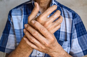 Wall Mural - Fingers and hands of Asian elder man. Concept of hand pain, rheumatoid arthritis and finger problems.