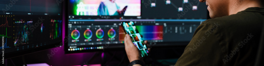 Editor Back Back view of a young white man video editor Stock Photo | Adobe Stock