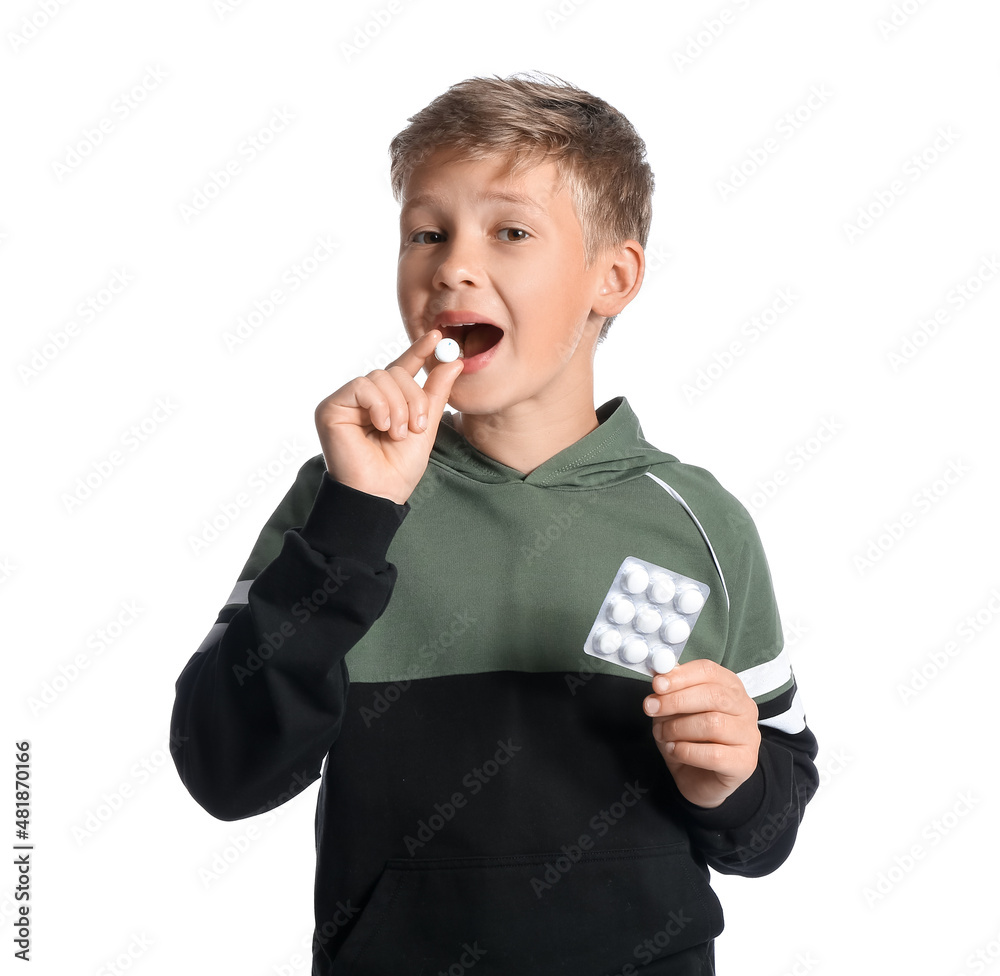 Little boy in hoodie with chewing gums on white background