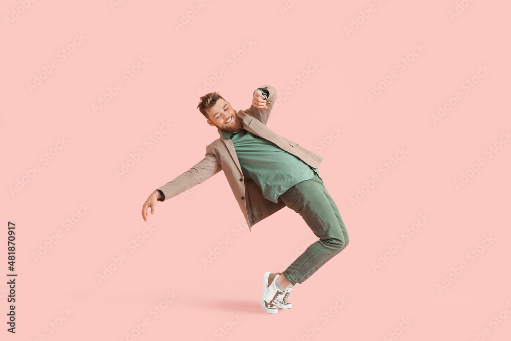 Cool dancing young man on color background
