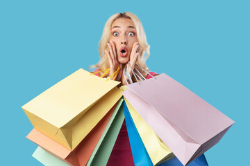 Overjoyed lady sitting with shopping bags at studio