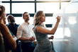 © Nola Viglietti/peopleimages.com - Spreading her tasks around. Shot of a pregnant businesswoman giving a presentation in the boardroom.