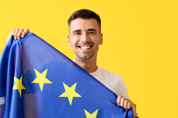 Sticker - Young man with flag of European Union on color background