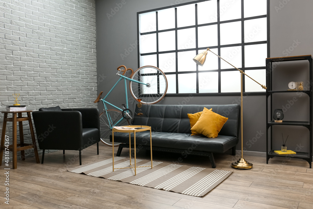 Interior of modern flat with sofa, table, armchair and  bicycle