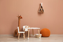 Cute Child Room Interior With Furniture, Toys And Wigwam Shaped Shelf On Pink Wall
