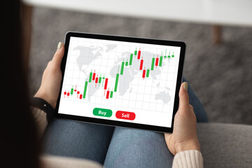 Aufkleber - Unrecognizable woman using trading application on digital tablet, home interior