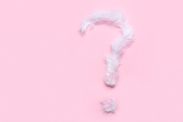 Question mark made of white feathers on pink background