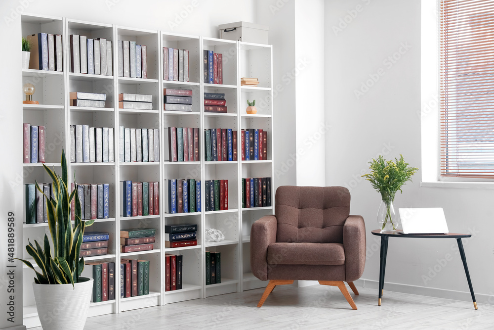 Bookcase with armchair in modern interior of room Stock Photo | Adobe Stock