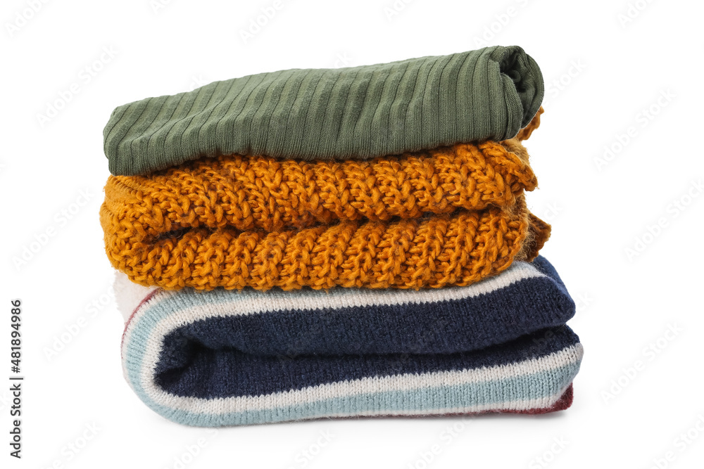 Stack of stylish soft sweaters on white background