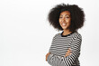 © Cookie Studio - Lifestyle and people. Beautiful african woman, smiling and looking happy, healthy and confident pose, standing against white background