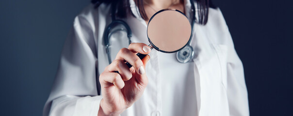 Wall Mural - the doctor stands with a magnifying glass