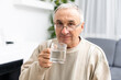 © Angelov - Male senior citizen in shirt drinking water