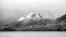 Black And White Beautiful Landscape Image Of Caste Crag Shrouded In Mist During Autumn View Along Derwentwater In Lake District