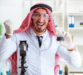 Wall Mural - Arab chemist scientist testing quality of oil petrol