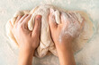 © Надежда Урюпина - hands in flour crumple the dough for pizza or pies, the process of cooking bakery products