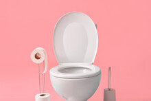 Holder With Rolls Of Paper, Toilet Bowl And Brush On Color Background, Closeup