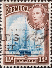 Wall Mural - Bermuda - circa 1938: a postage stamp from Bermuda, showing den historischen Hafen von Hamilton mit segelschiffen un dem Porträt of King George VI