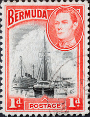 Wall Mural - Bermuda - circa 1938: a postage stamp from Bermuda, showing den historischen Hafen von Hamilton mit segelschiffen un dem Porträt of King George VI