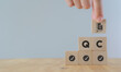 © Parradee - Quality control (QC) concept. For business and industry. Standard qulity,guarantee, process, check and approvement. Hand hold wooden cubes with guarantee icon standing on abbreviation QC and pass icon