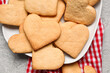 © Pixel-Shot - Plate with tasty heart shaped cookies on table, closeup. Valentines Day celebration
