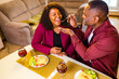 © yurakrasil - african american couple in love drinking wine from glasses and eating italian pasta in living room 14 february valentines day