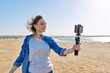© Valerii Honcharuk - Mature woman recording video on smartphone, making a stream