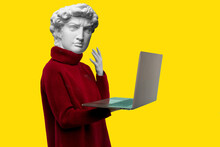 Abstract Modern Collage. The Man With The Plaster Head Of David In A Red Sweater Looks At A Laptop Screen On A Yellow Background