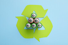 Used Batteries And Recycling Symbol On Light Blue Background, Flat Lay