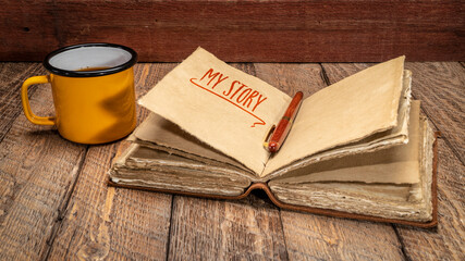 Sticker - my story - handwriting in a retro  leather-bound journal with decked edge handmade paper pages and cup of tea on rustic wood, journaling concept