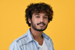 © insta_photos - Young curly smart indian cool guy standing isolated on yellow background. Ethnic cool handsome man wearing denim shirt looking at camera posing for headshot close up face portrait.