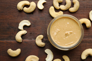 Sticker - Delicious cashew butter and ingredients on wooden table, flat lay