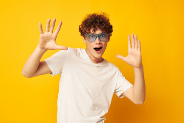 Young curly-haired man in blue glasses white t-shirt fashion modern style isolated background unaltered