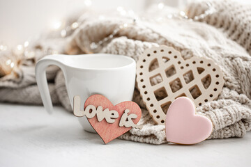 Wall Mural - Cozy composition for Valentine's Day with a cup and decor details.