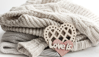 Wall Mural - A decorative heart among cozy knitted items. Valentine's Day holiday concept.