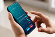 © Thapana_Studio - Businessmen work with stock market investments using smartphone to analyze trading data. smartphone with stock exchange graph on screen. Financial stock market.