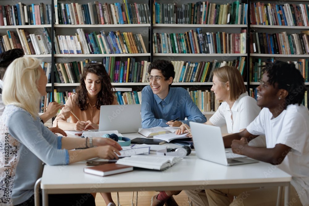 Happy diverse students working on a group project