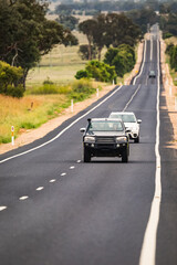 Wall Mural - Cars travelling along a very long, straight single lane paved highway in rural New South Wales, Australia.