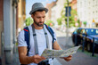 Male tourist reading map on European city break