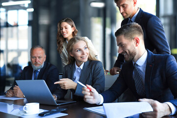 Wall Mural - Group of business partners discussing ideas and planning work in office.