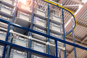 Fototapete - Huge distribution warehouse with high shelves and loaders. Bottom view.