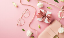 Top View Photo Of Woman's Day Composition Pink Leather Handbag Stylish Glasses White Giftbox With Bow Scrunchies And White Prairie Gentian Flower Buds On Isolated Pastel Pink Background With Copyspace