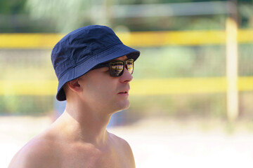 Summer portrait of a man in a sun hat. Side view