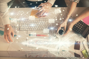 Poster - Double exposure of man and woman working together and the envelop hologram drawing. Computer background. Top View. Electronic mail concept.